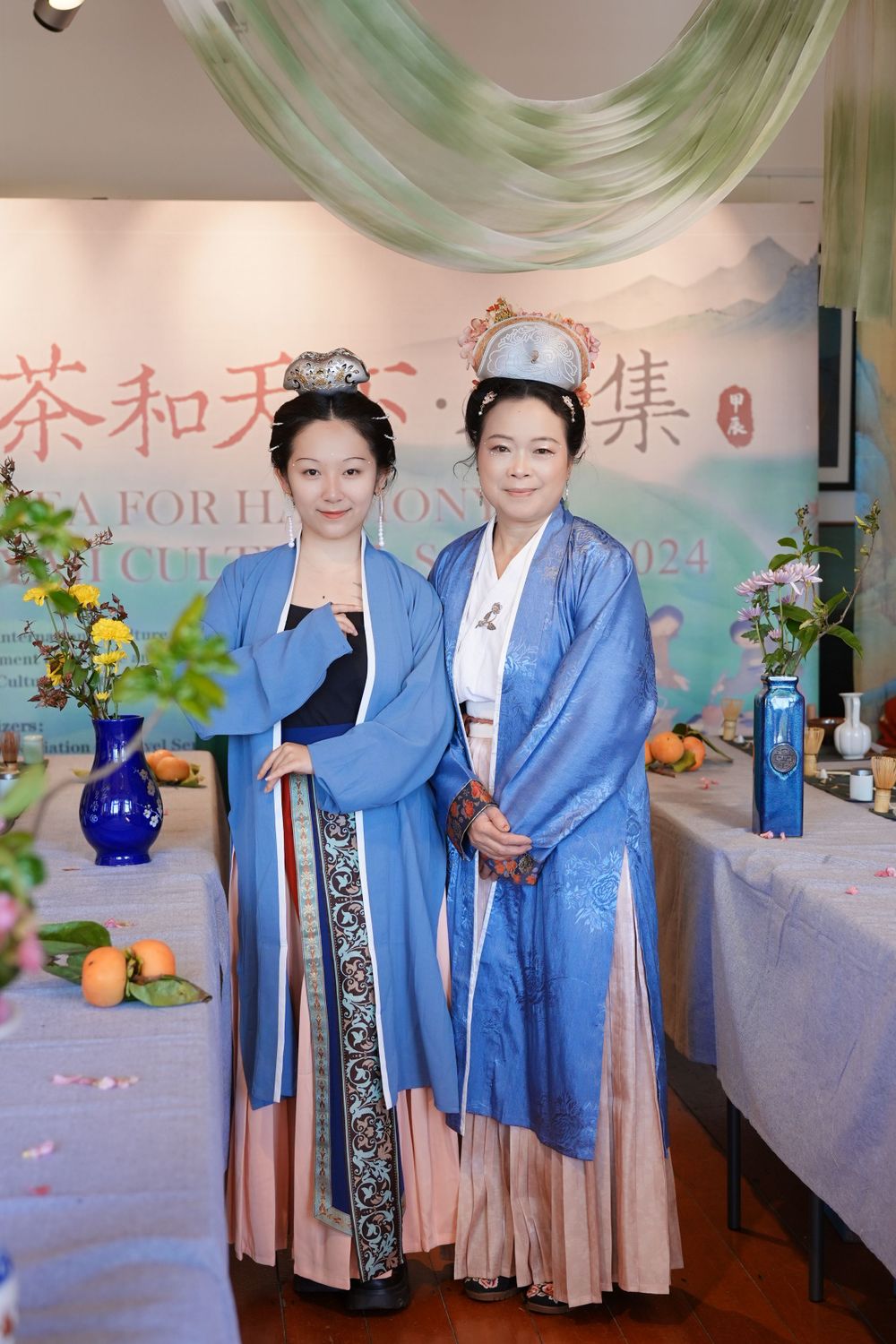 Event photography of diverse guests enjoying a traditional Chinese tea culture experience in Hanfu, by an Auckland photographer.