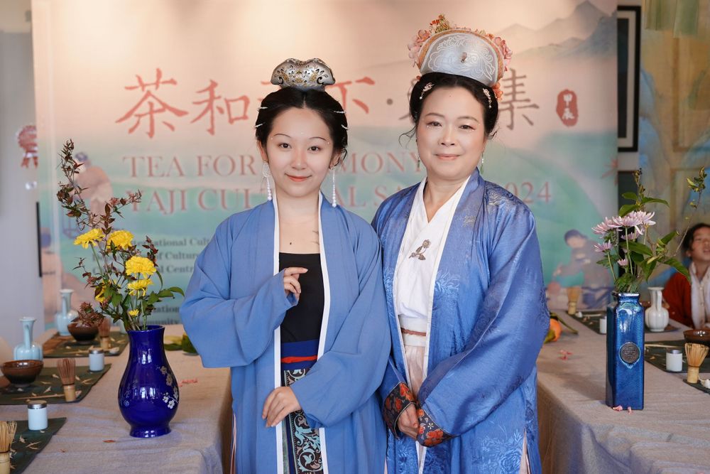 Event photography of diverse guests enjoying a traditional Chinese tea culture experience in Hanfu, by an Auckland photographer.