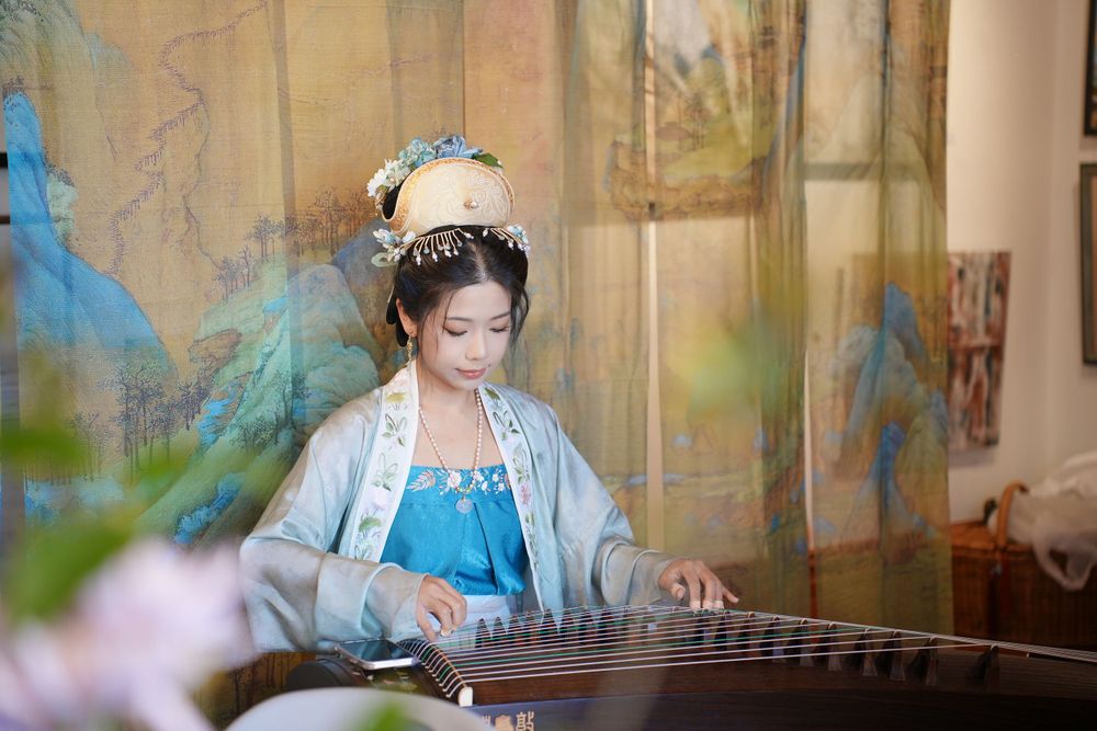 Event photography of diverse guests enjoying a traditional Chinese tea culture experience in Hanfu, by an Auckland photographer.