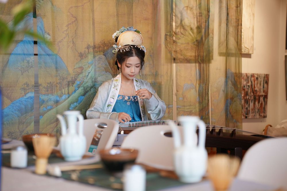 Event photography of diverse guests enjoying a traditional Chinese tea culture experience in Hanfu, by an Auckland photographer.