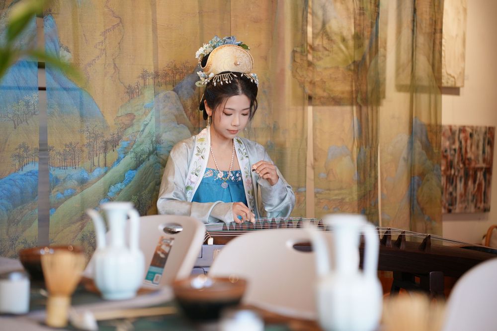 Event photography of diverse guests enjoying a traditional Chinese tea culture experience in Hanfu, by an Auckland photographer.