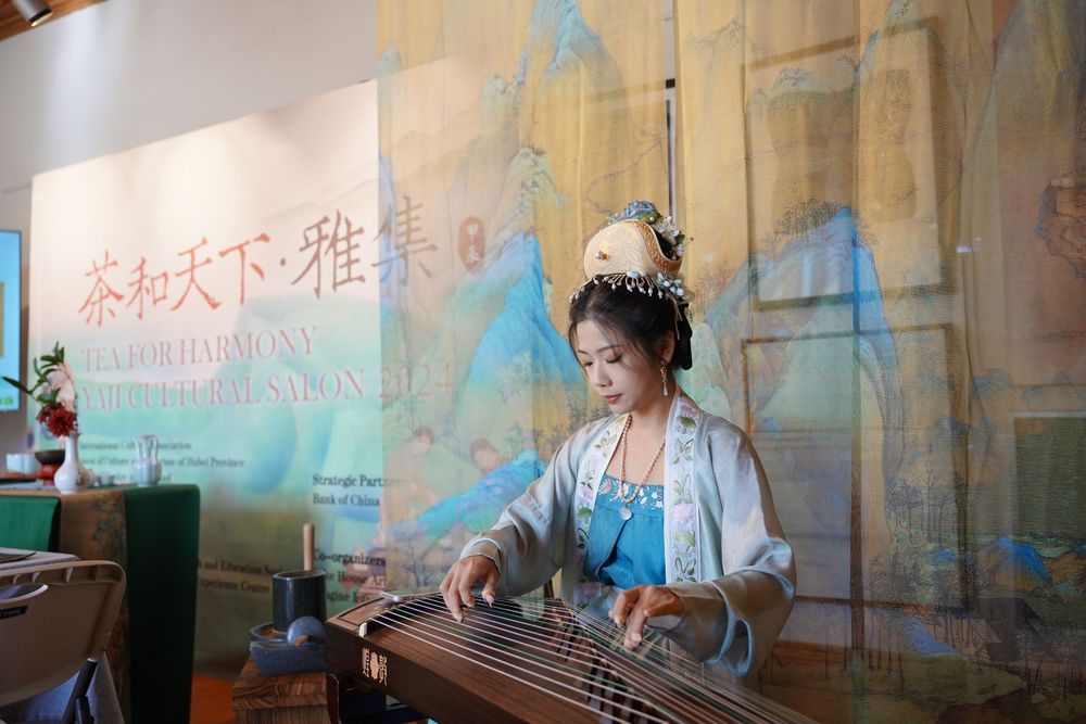 Event photography of diverse guests enjoying a traditional Chinese tea culture experience in Hanfu, by an Auckland photographer.