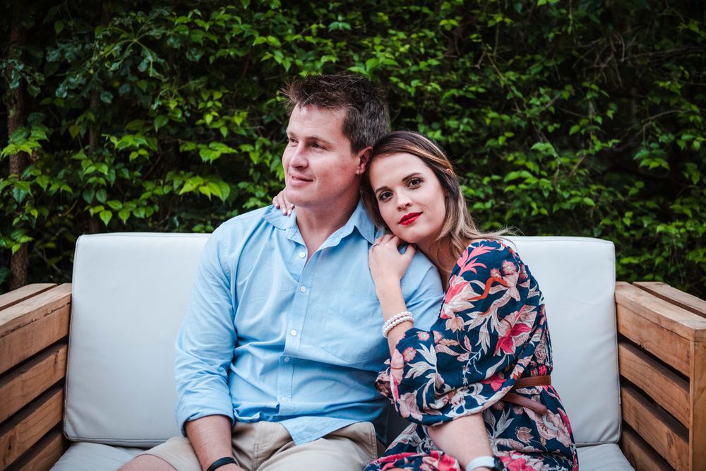 Intimate shot of a couple sitting on a bench for their engagement shoot.
