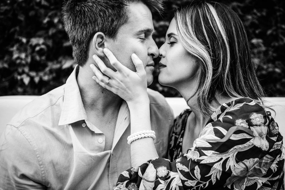 Close-up black and white photo of the couple touching foreheads.