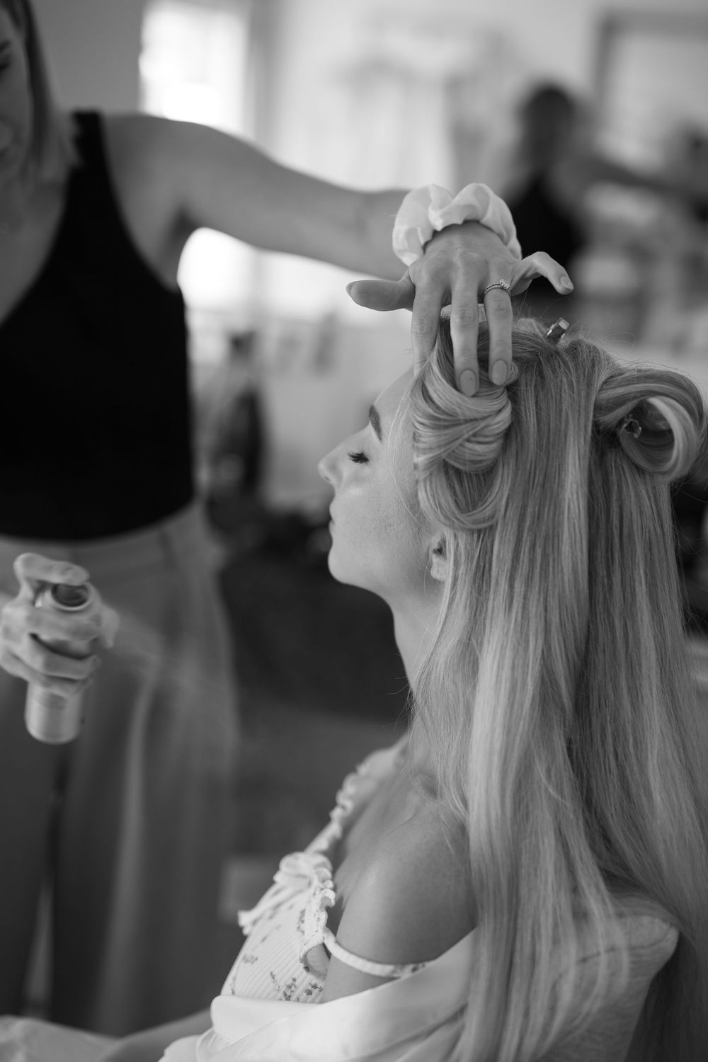 Black and white sequence showing preparation of a bride's hair being styled for her wedding day.