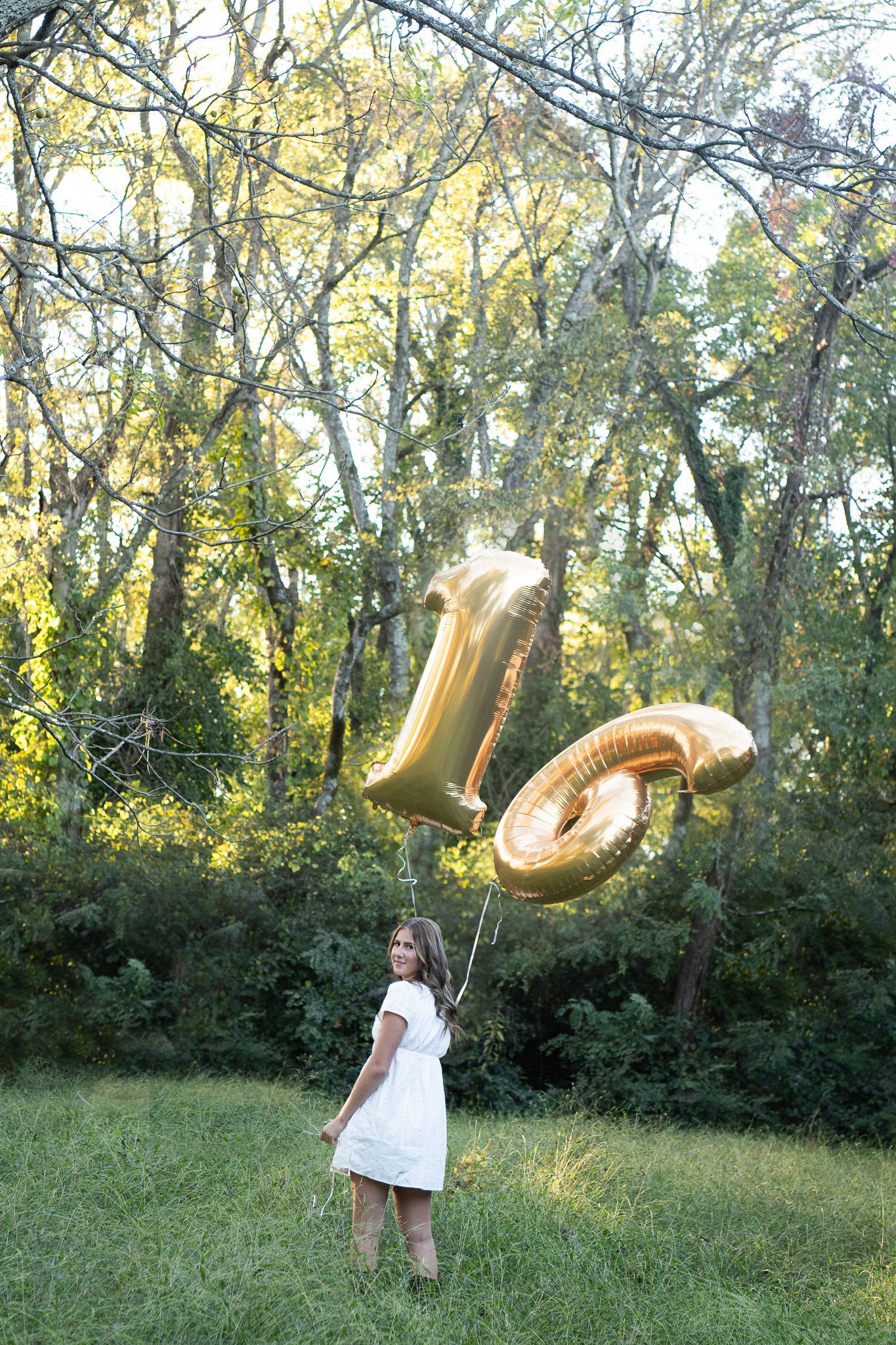 A sequence of photos showing gold number balloons flying and floating away in a wooded outdoor setting.