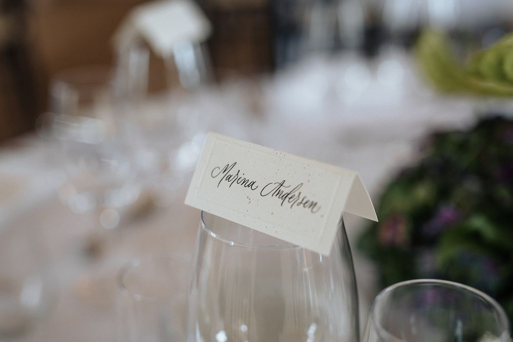 Elegant white place cards and table settings arranged for a formal wedding reception or dinner party.