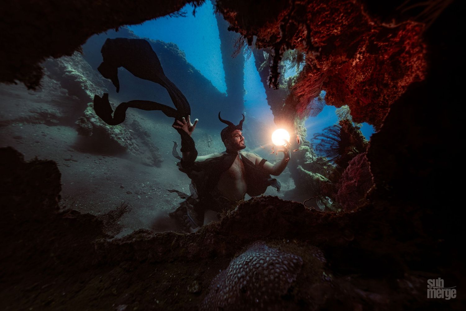 A dark and moody scene from the video game God of War Ragnarok shows a warrior exploring a mystical cave environment.