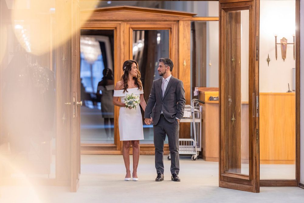 Long hallway interior with wooden doors and warm lighting.