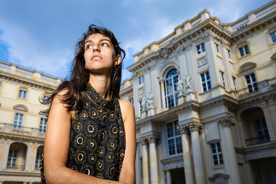 Architectural photography of ornate European building facade in bright sunlight.
