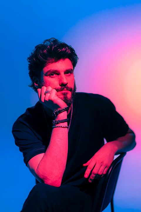Artistic portrait series with dramatic red and blue lighting against dark background.