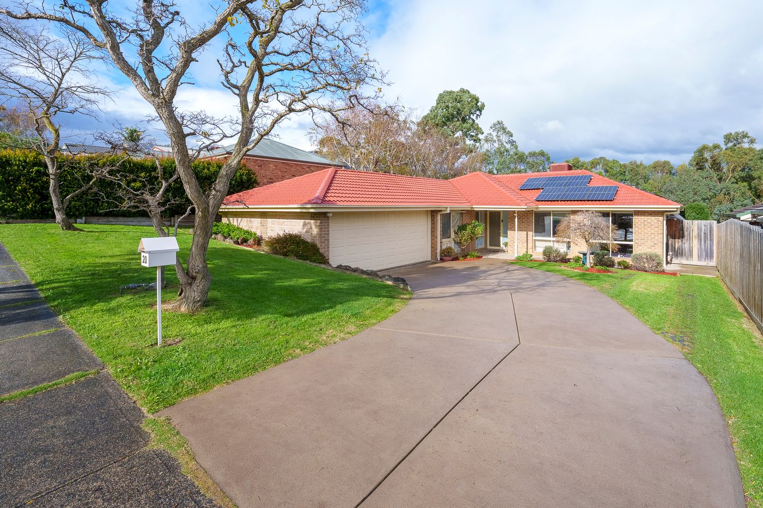 Luxury modern home with a large swimming pool, outdoor entertaining area, and panoramic suburban views.