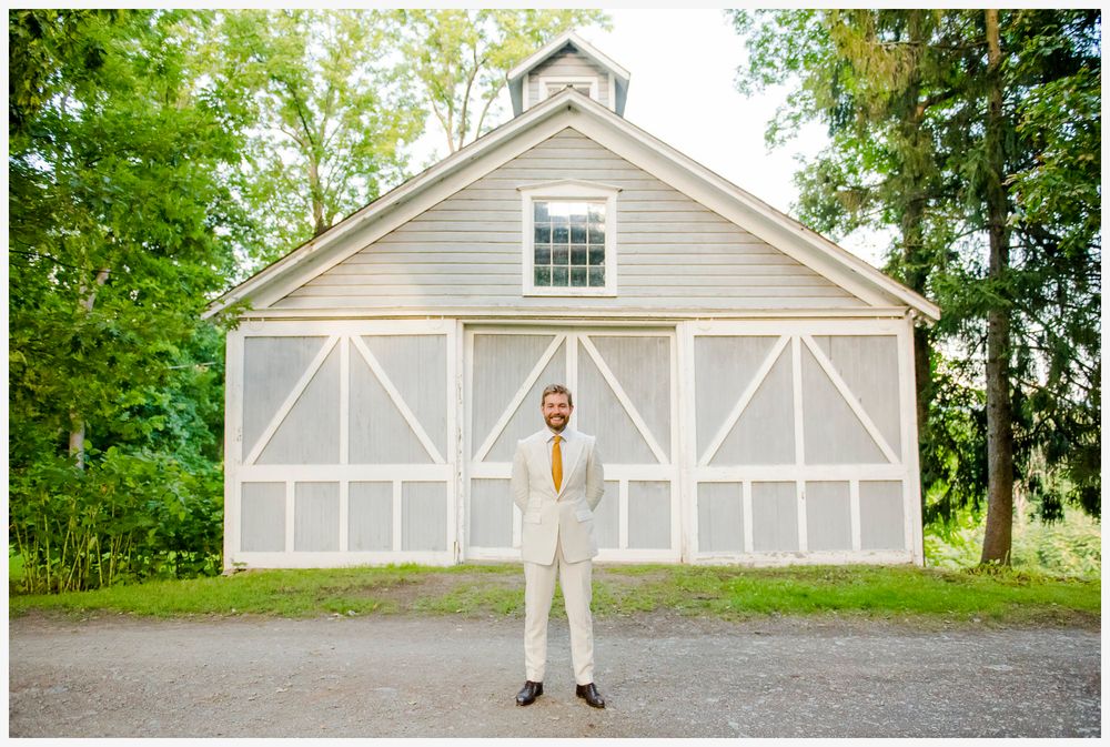 White barn wedding venue with classic architectural details and symmetrical design.