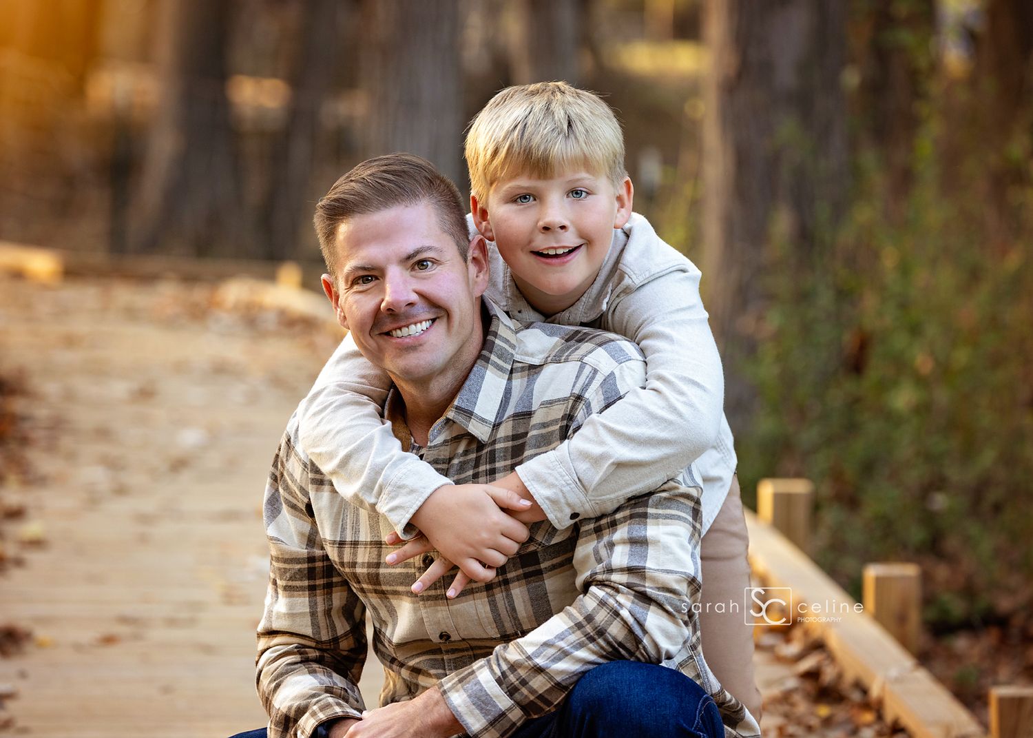 A playful family moment captured in autumn with warm sunlight filtering through trees in a park setting.