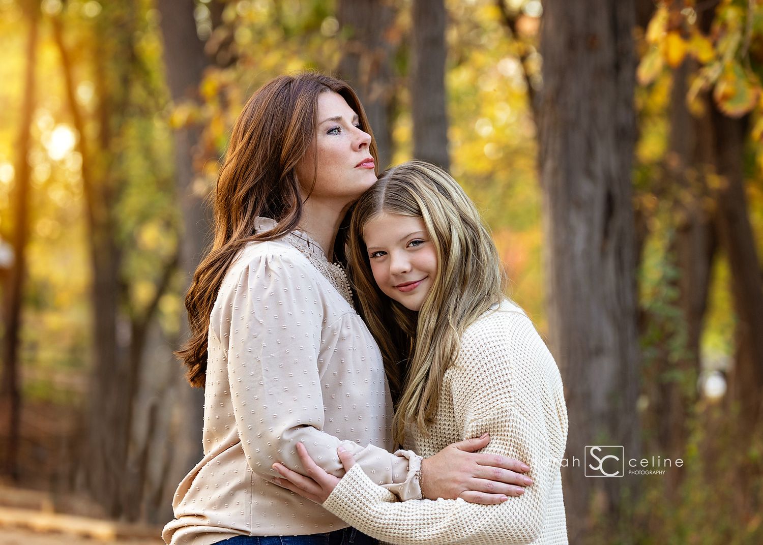 Candid outdoor portrait session showing tender embraces against a backdrop of golden fall foliage.