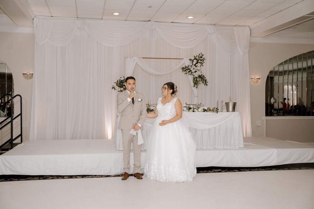 Wedding dance floor with white draping and romantic lighting creating an intimate atmosphere.