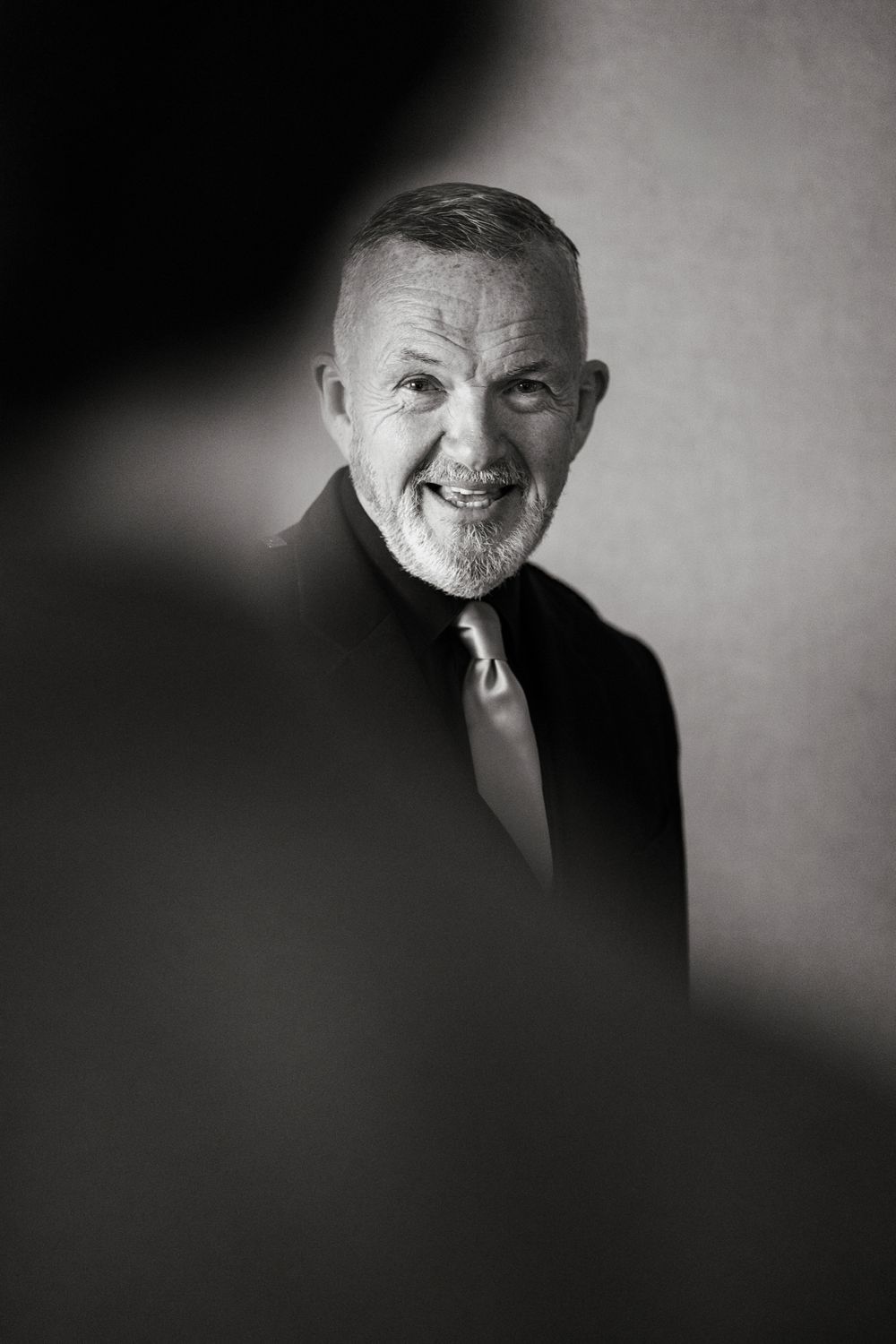 Black and white artistic portrait series showing dramatic lighting and shadows against a dark background.