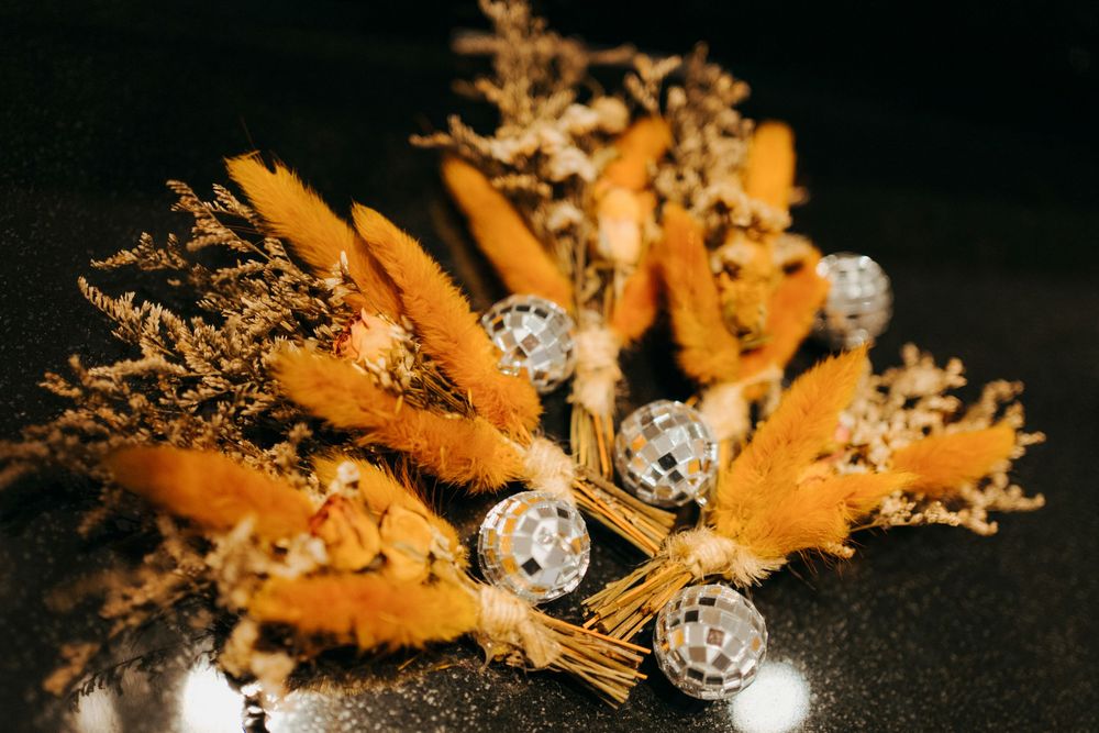 Macro photo of orange cheese curls and white speckled balls arranged artistically against a dark background.