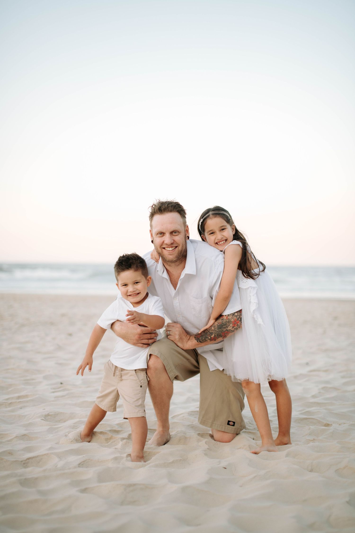 Family moment captured on a beach during sunset.
