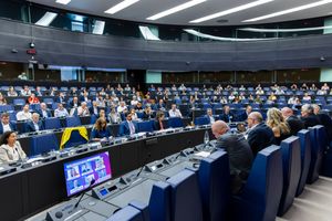European Parliament session with delegates seated in a modern hemicycle chamber during an official assembly meeting.