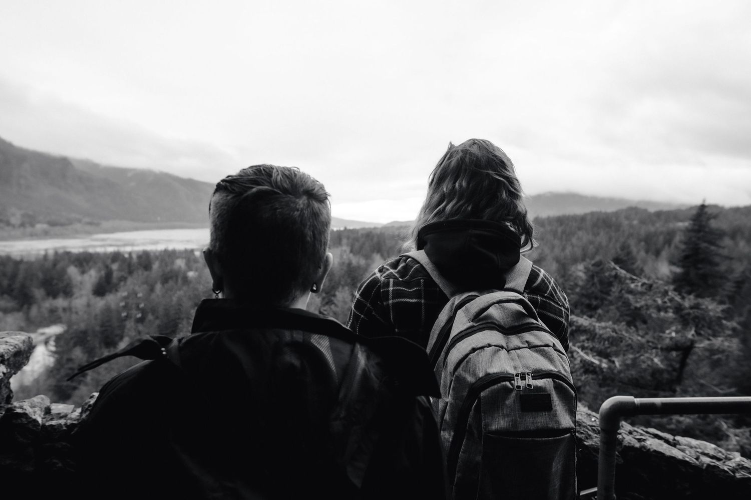 Couple looks out at the view of the Columbia River before starting their hike up to Beacon Rock.