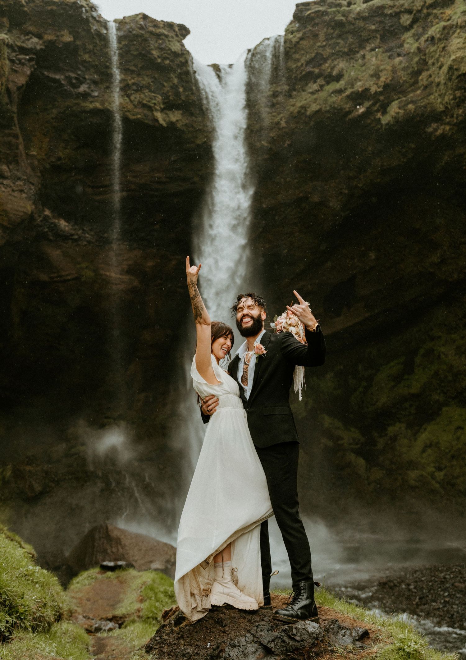 Newlywed couple celebrates joyfully with confetti falling around them during their wedding reception.