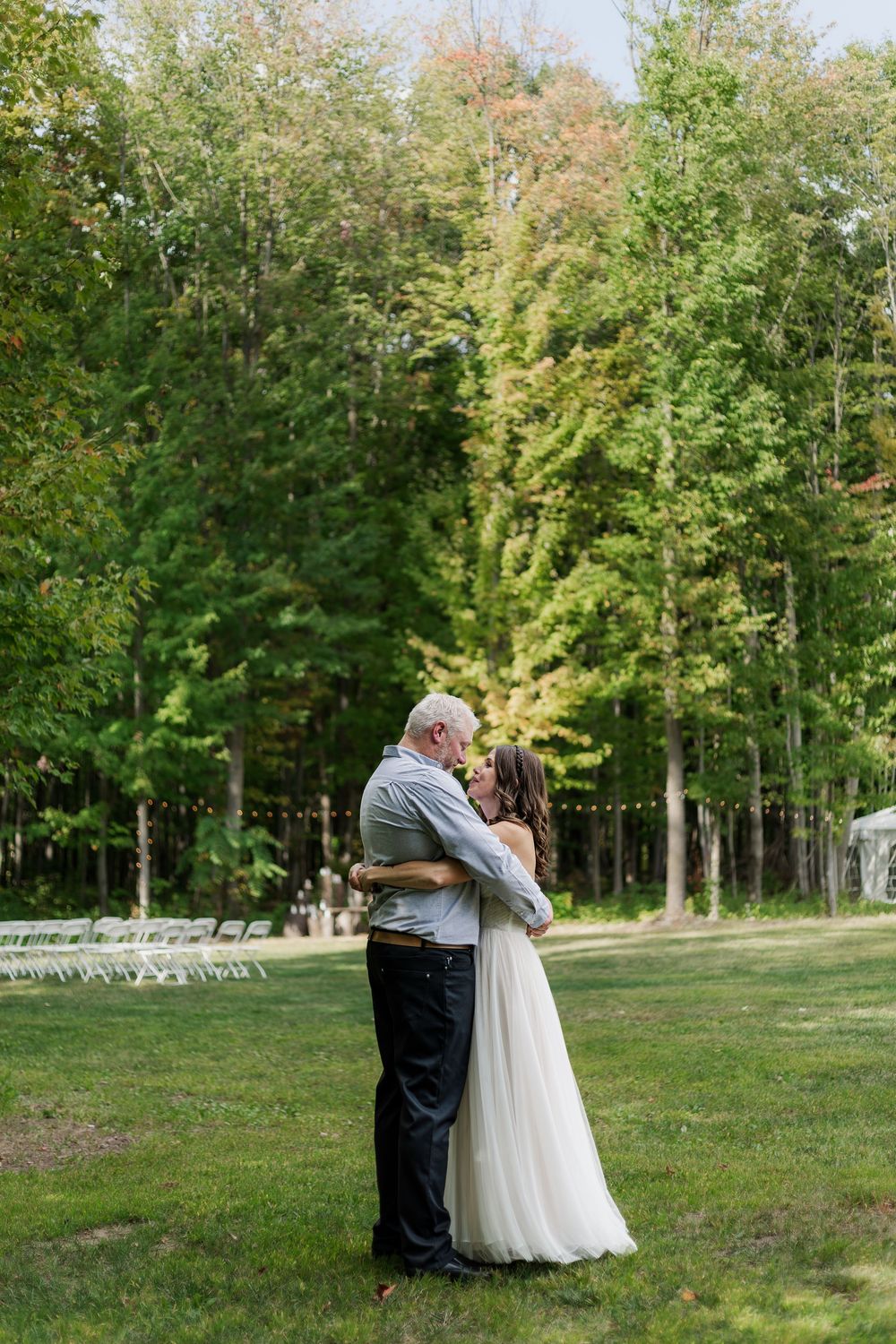 Natural wedding photo of bride and groom embracing after their first look in during a backyard summer wedding near woodstock, ontario.