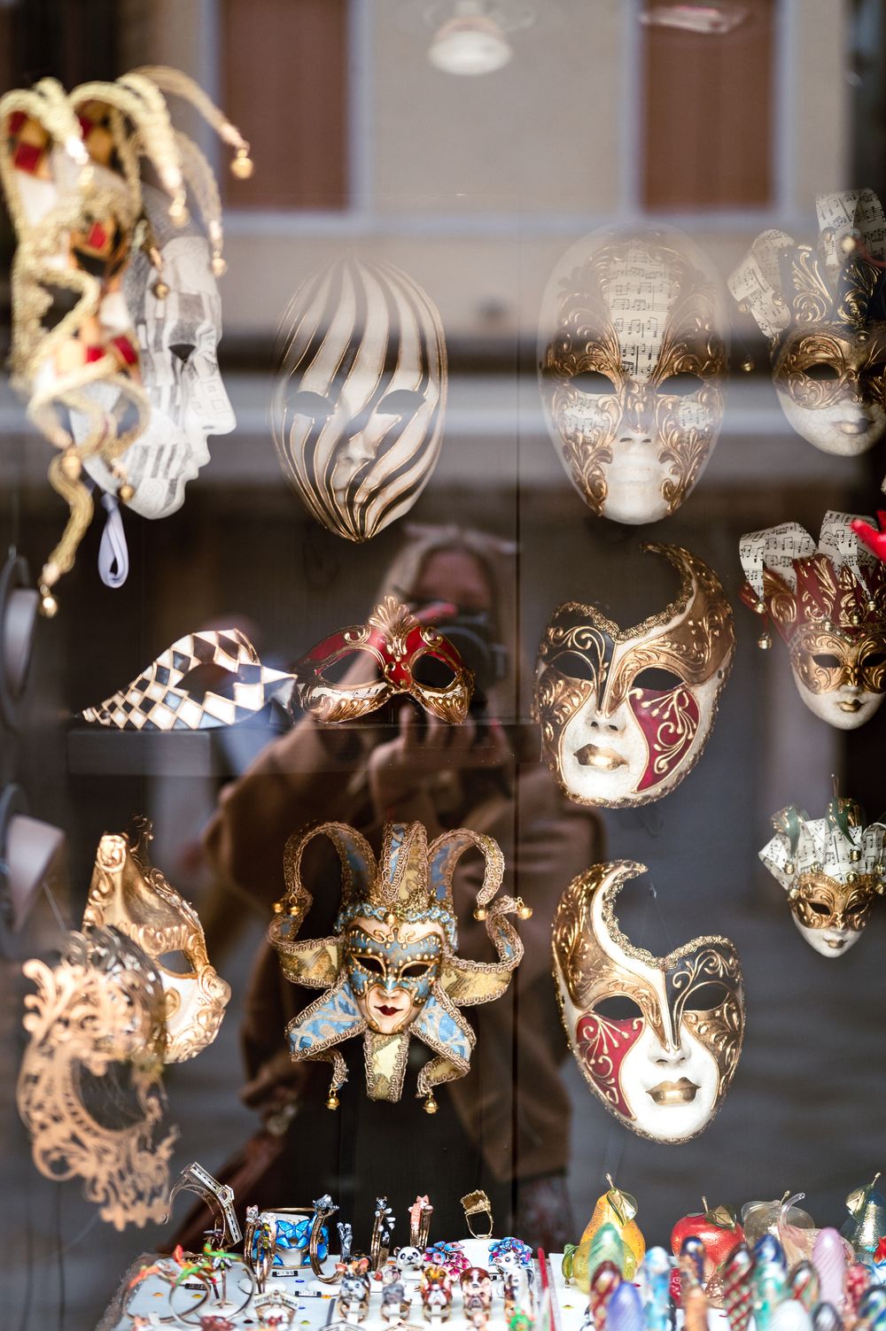 Colorful Venetian carnival masks displayed in a shop window in Venice, Italy.