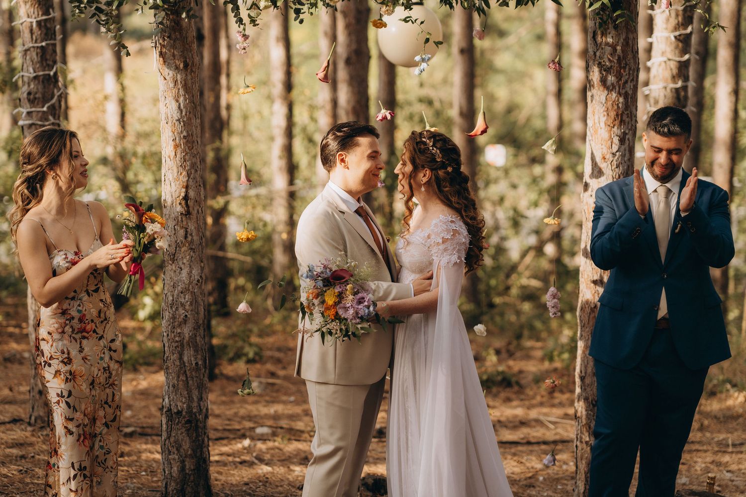 Couple exchanges vows in a romantic forest wedding ceremony, surrounded by tall pine trees and wildflower bouquets.