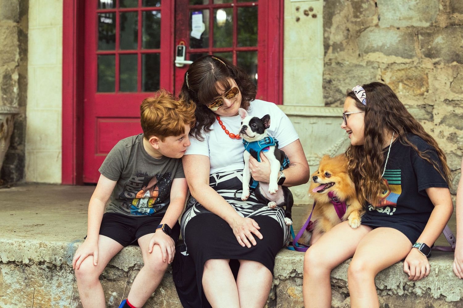 Lifestyle portrait of family with 2 dogs