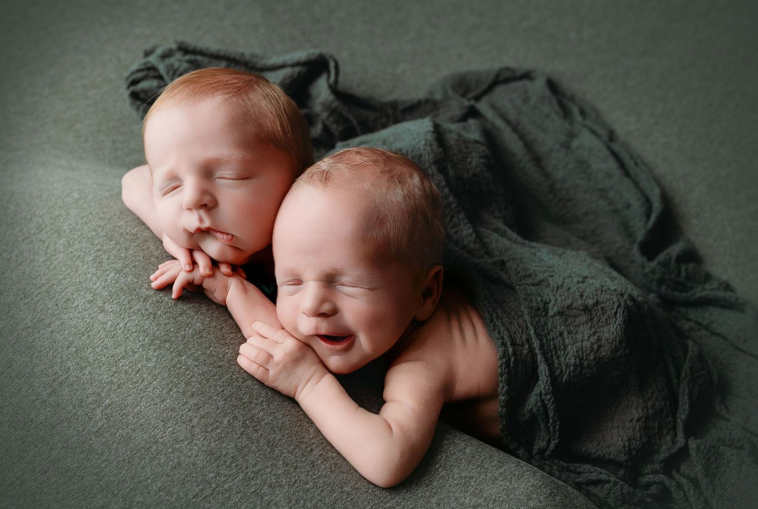 Twins together smiling, doing the chin-on-hands pose. Greenville SC newborn photographer, Easley SC newborn photographer