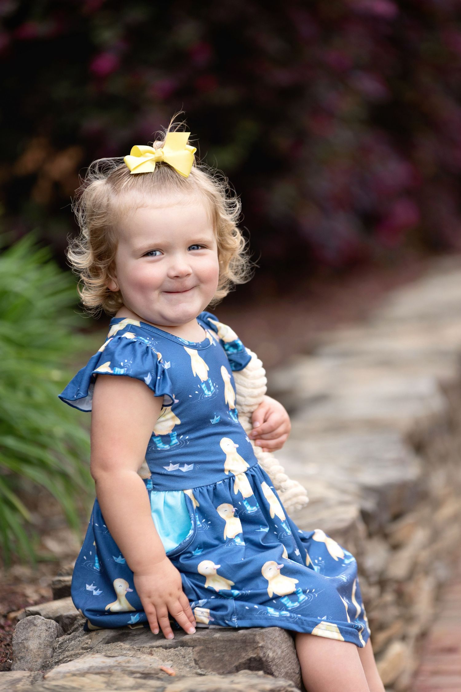 A two-year-old little girl with curls grinning. Greenville, SC newborn photographer. Easley, SC Newborn photographer