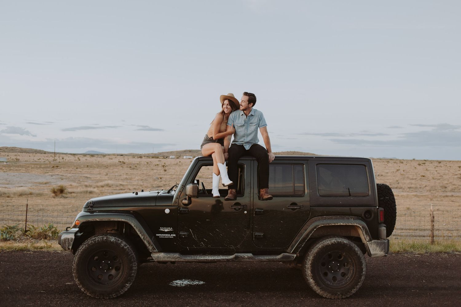 Desert photoshoot sequence featuring a black Jeep and distant mountain landscape.