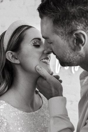 An intimate black and white close-up moment between a couple on their wedding day.