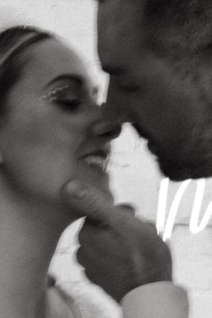 An intimate black and white close-up moment between a couple.