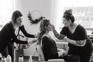Behind-the-scenes moment of wedding preparation with styling team at work.