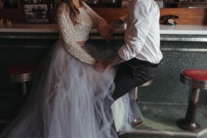 Wedding couple sharing romantic moment at vintage bar.