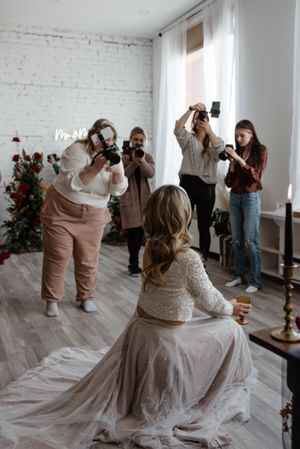 Behind the scenes of wedding photographers capturing bridal portraits.