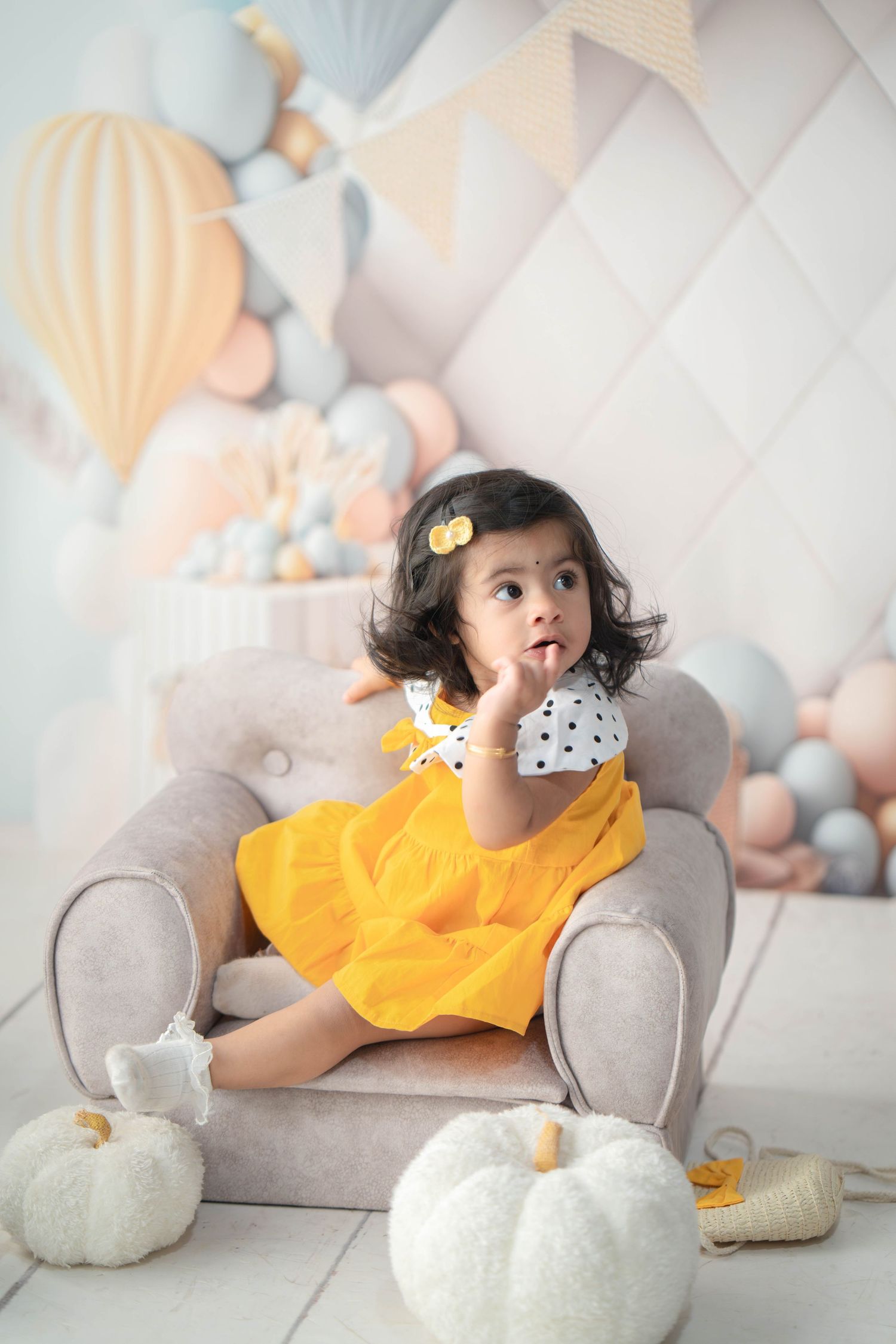 One-year-old baby clapping joyfully with cake all over face and hands