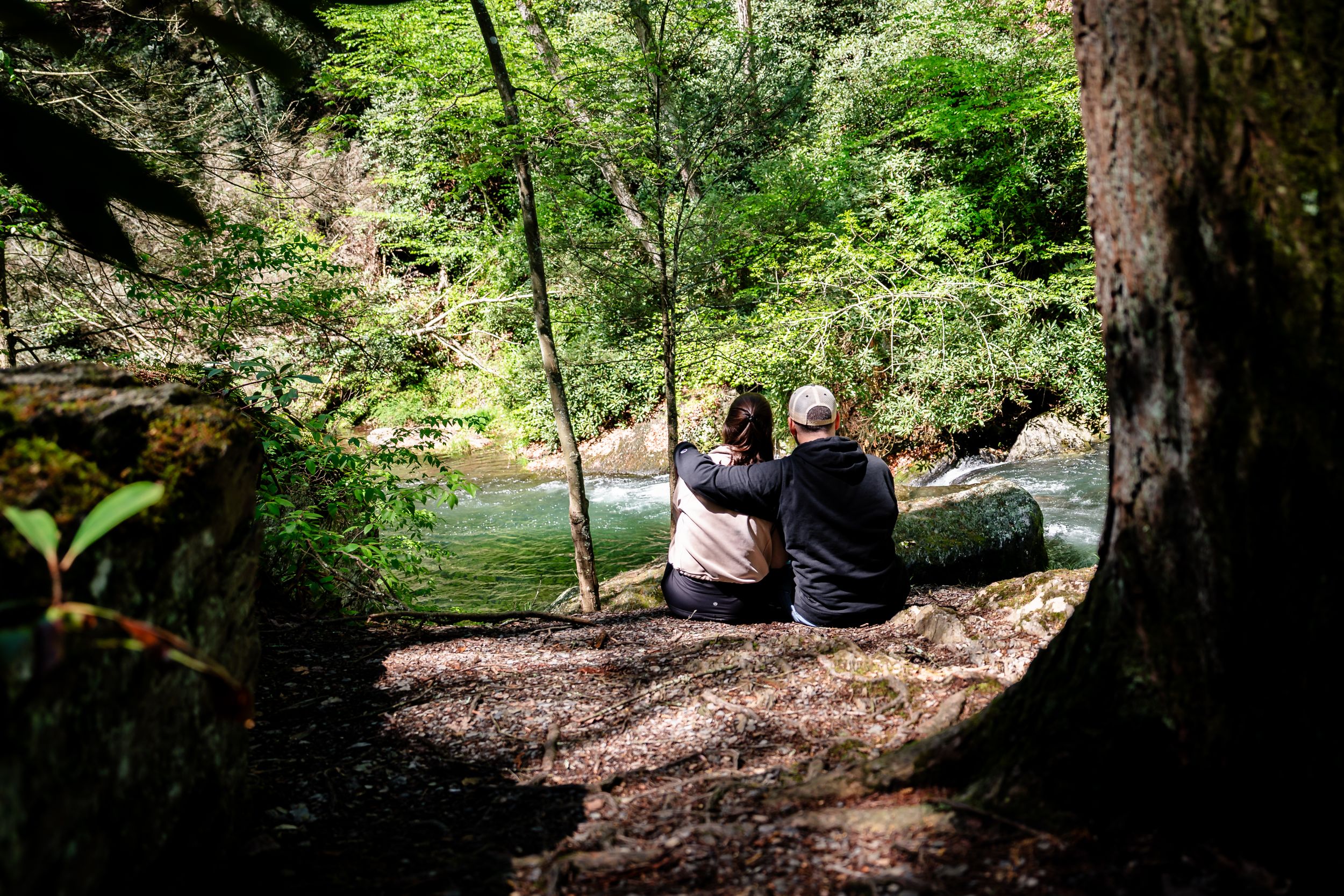 People enjoying a peaceful moment in a green forest setting.