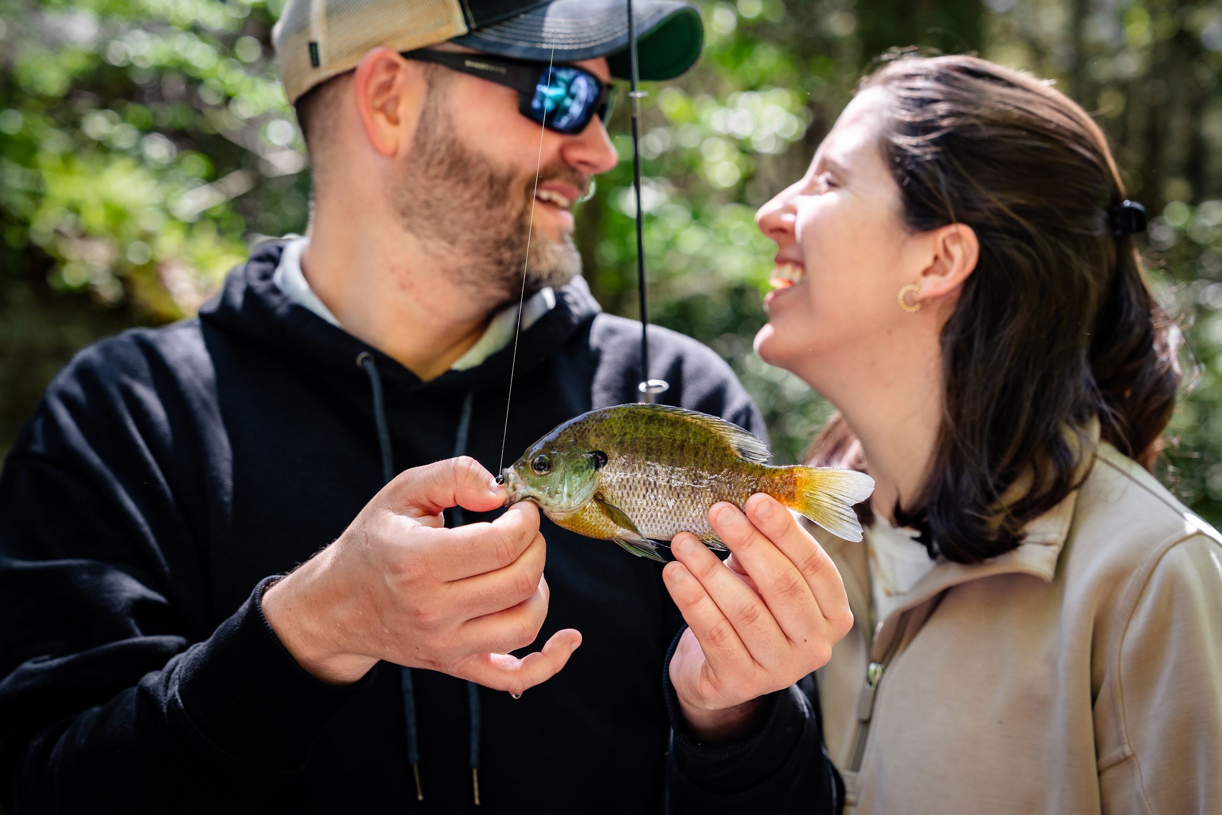 Two people share laughs while spending time outdoors in nature.