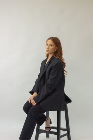 A person wearing a black off the shoulder top at a portrait photography session.