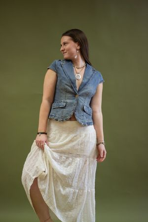 A person wearing a denim vest and white lace skirt poses in a series of dynamic shots against a green background. Branding photos, portraits