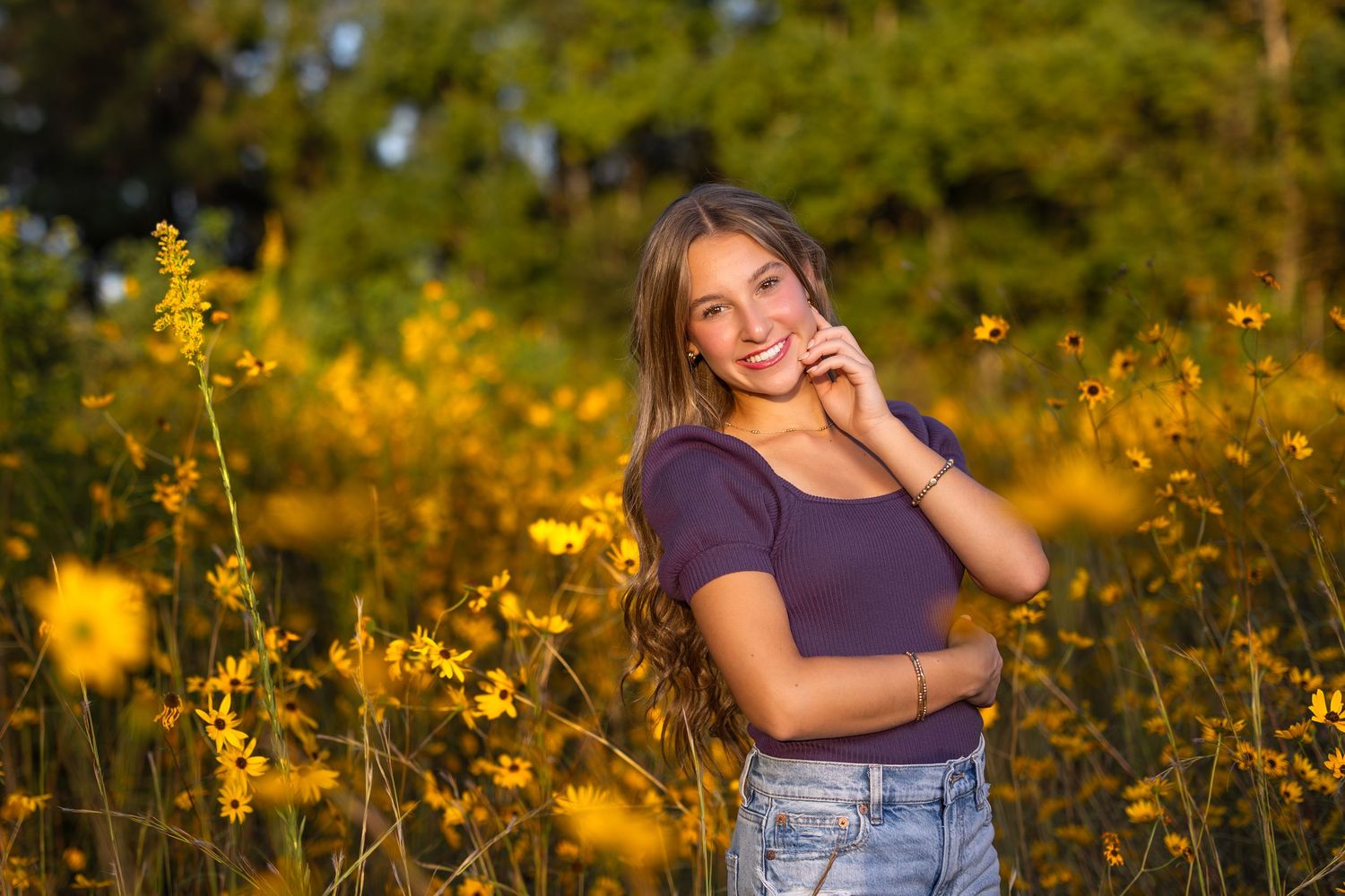 Golden hour portrait session in a field of yellow wildflowers during sunset.