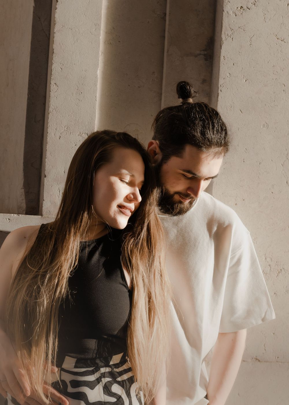 A romantic photo sequence showing tender moments between a couple in contrasting black and white outfits.
