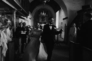 Dramatic black and white shots of wedding reception dancing in a dimly lit venue.