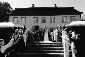 Black and white photo of a rustic wedding venue with classic architecture.