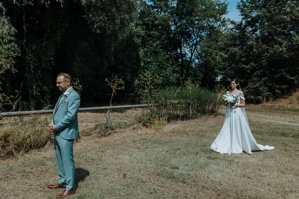 Wedding couple sharing intimate moments in an outdoor garden setting.