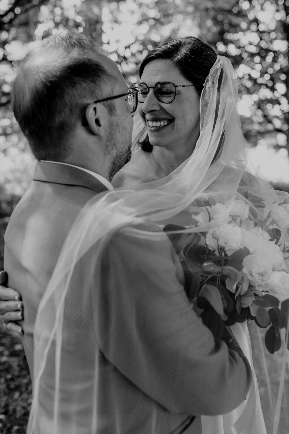Black and white wedding portrait captured in natural outdoor lighting.