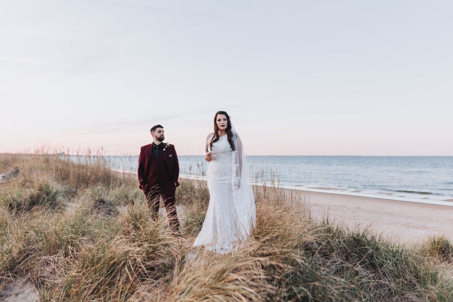 Wedding guests hold sparklers creating a magical tunnel of light as the couple exits their reception celebration.